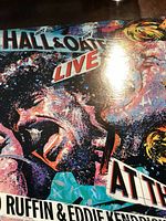 Close-up of Hall and Oates Live vinyl record cover showing colorful stylized artwork and partial text.