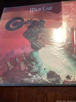 Front cover of Meat Loaf's 'Bat Out of Hell' vinyl record, showing dramatic motorcycle artwork and album title.