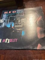 Front cover of the REO Speedwagon Hi Infidelity album showing the title and artwork