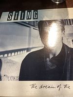 Front cover of Sting's 'The Dream Of The Blue Turtles' album showing black and white photo of Sting and album title text.