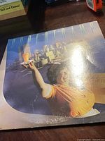 Front cover of Supertramp vinyl record album with waitress holding orange juice glass, kitchen background