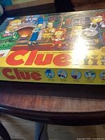 Box top artwork showing The Simpsons characters and Clue logo