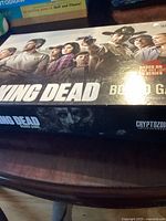 Box cover of The Walking Dead board game showing characters from the TV series