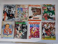 Top view of 8 football magazines laid out showing variety of cover art from 1970s and 1980s NFL magazines GameDay, Sports Insider, and Pro!
