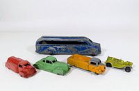 Five vintage die-cast toy vehicles arranged side by side on white background, showing wear and missing wheels