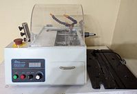 Front view showing entire unit with control panel, safety hood, base