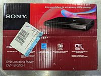 Original packaging front side with barcode sticker and product image of the DVD upscaling player.