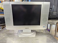Front view of the Sylvania 19 inch LCD TV showing the screen and built-in speakers on each side.