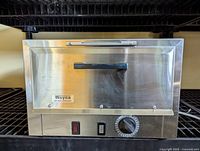 Front view of the Wayne dry heat sterilizer showing the stainless steel exterior, handle, and control panel with timer dial and switches.