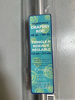 Label showing product details, adjustable drapery rod 48 in. to 84 in., mounting hardware included, made by Creations.