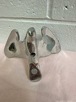 Front view of aluminum hawk sculpture with wings spread and shiny metal finish