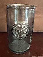 Full view of cylindrical drinking glass made of recycled glass showing embossed Vidrios San Miguel logo