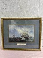 Full view of the framed print showing a maritime scene with sailing ships and a gold ornamental frame.