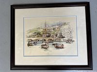 Full view of framed 'Looe' print by Eric Mason showing coastal harbor scene with boats and hillside village.