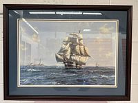Full view of the large framed nautical print showing a sailing ship and lighthouses on ocean waters.