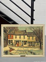 Full front view of framed print against wall