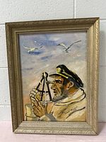 Full frontal photo of the painting showing sailor using sextant, seagulls and sky in background within ornate wooden frame.