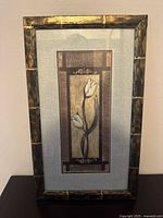 Full view of framed flower artwork showing frame and art print