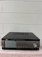 Front view of Rolkolsen R-70A 5.1 channel AV surround integrated amplifier showing display panel, volume knob, and control buttons.