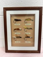 Framed shadow box showing all six fly fishing flies mounted labeled and spaced evenly.