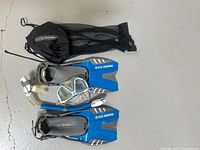 Full kit showing fins, snorkel, diving mask and mesh carrying bag