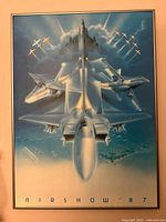 Framed vintage 1987 International Air Show poster showing five fighter jets flying in formation in blue sky with light rays.