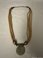 Full view of the vintage multi-strand wooden bead necklace showing the wooden beads, metal beads, and pendant.