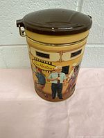 Front and side view of vintage Tim Hortons collectible tin can with lid and retro illustrations