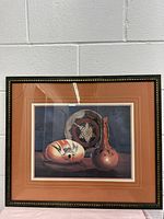Full view of framed print showing three Native American pottery pieces with black and gold frame.