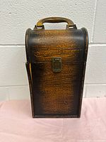 Front view of the vintage handcrafted wooden wine box showing the intact latch and handle and wood grain finish.