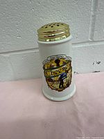 Front side view of the vintage grated cheese shaker with visible colorful decal and text 'Buona San Remo Italia Cheese'.