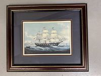 Framed vintage print showing full ship and frame edges, neutral background
