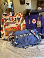Group shot of two Kånken backpacks and Kipling crossbody