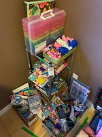 Overall view of shelf unit with craft keeper, lap desk and multiple craft supplies