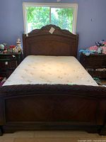 Full view of bed with headboard, footboard, mattress, and surrounding nightstands