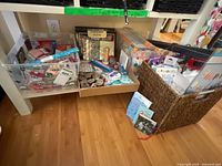 Overall view of bins containing assorted craft supplies, greeting cards, gift bags and candles