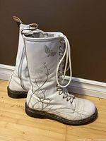 Side view of both boots showing graphic print, laces, sole