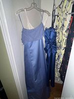 Overview of four dresses hanging in closet