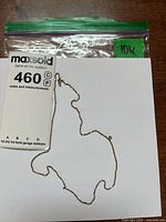 Chain necklace coiled beside lot tag