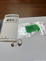 Earrings with MaxSold lot card, zip bag labeled 14K