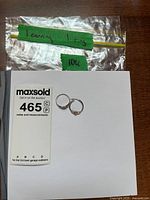 Ring and earring on white background with lot card