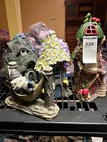 Overview of all three resin fairy houses on shelf