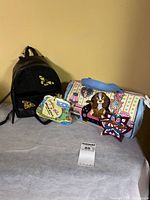 Group shot of all three items: dog handbag, Hello Kitty coin purse, black mini backpack