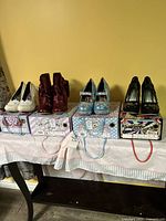 All four shoe pairs on their original Irregular Choice boxes