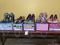 Wide shot of five pairs of Irregular Choice shoes on their boxes