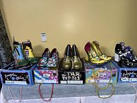 Five boxed pairs of Irregular Choice shoes displayed on table