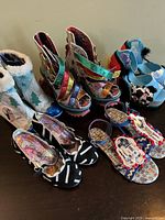 Overview of six pairs of novelty shoes on tabletop