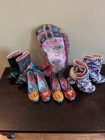 Group shot of five pairs shoes and Texas boot bag