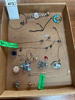 Entire lot in box showing all jewelry pieces with labels