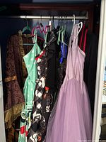 Multiple dresses hanging in closet